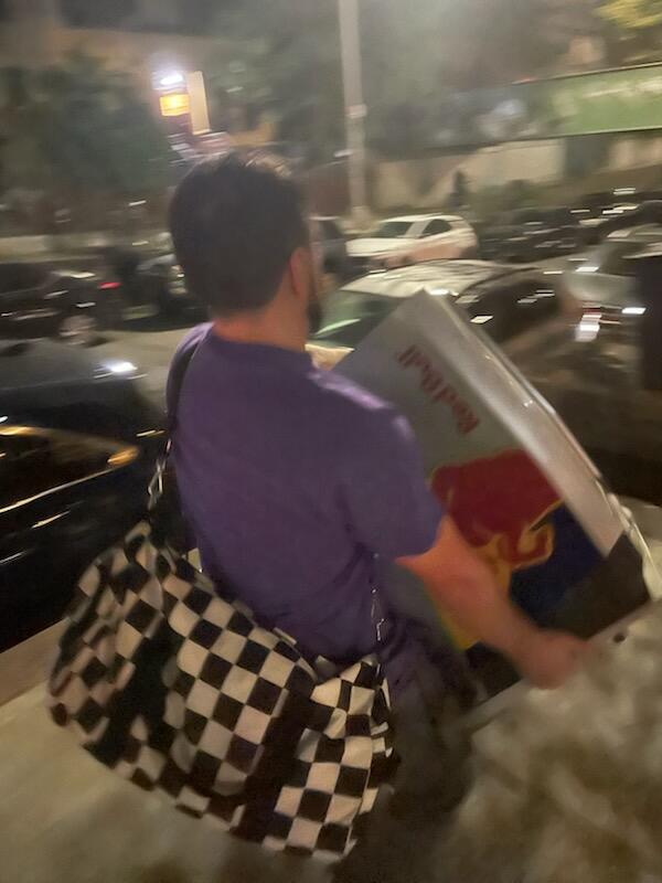 Me hauling a Red Bull fridge up the stairs like an absolute menace.